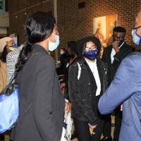 People in suits and wearing masks